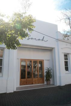 a white building with wooden doors and windows