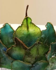 a close up of a green flower on a plate