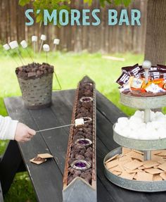 there is a cake bar on the table with marshmallows and other treats