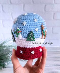 someone is holding up a crocheted christmas ornament