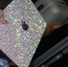 someone is holding an iphone in their hand with glitter on the back and bottom cover