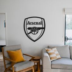 a living room filled with furniture and a wall mounted shield sign on the wall above it