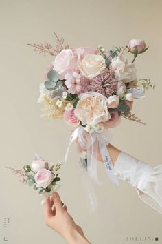 two hands holding bouquets with flowers on them