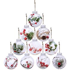 twelve glass baubles with holly berries and pine cones hanging from a rope on a white background