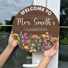 two hands holding up a sign that says, welcome to mrs smith's classroom