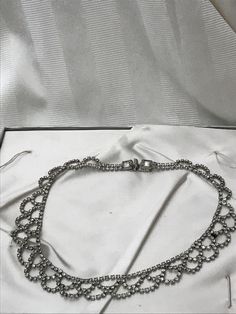 "1950's rhinestone costume jewelry. Bib style necklace in excellent vintage condition. All rhinestones are present on this piece. Lovely piece of costume jewelry for a wedding accessory. Measurements are; 16 1/2\" x 3/4\" Feel free to convo me with any further questions. Thank you for your interest." Elegant Rhinestone Necklace For Vintage Events, Evening Diamond Necklace With Rhinestones, Vintage Diamond Necklaces For Evening, Elegant Necklaces With Sparkling Stones For Vintage Events, Vintage Diamond Necklace With 17 Jewels For Evening, Vintage Sparkling Stones Necklaces For Party, Round Rhinestone Metal Necklace For Wedding, Round Metal Rhinestone Necklace For Wedding, Formal Sparkling Rhinestone Metal Necklace