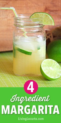 a mason jar filled with lemonade next to limes