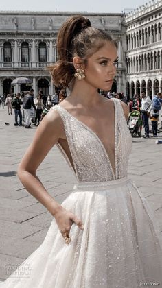 a woman in a white dress standing on the street