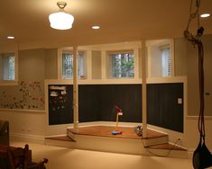 an empty room with blackboard and white walls