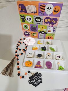 an open halloween card and some decorations on a table