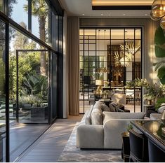 a living room filled with lots of furniture and plants on the side of the wall