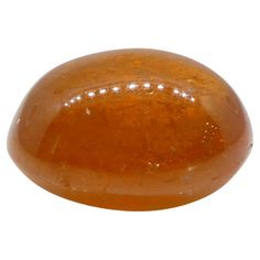 an orange colored rock on a white background