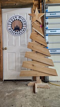 a small wooden christmas tree in front of a door