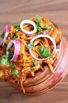 a wooden container filled with food on top of a table