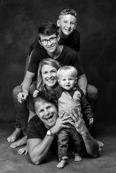 a family poses for a black and white photo