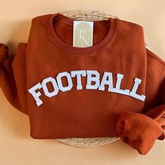 Cozy up with our Football Crewneck Sweatshirt this fall and Football Season!  - Sweatshirt is super soft and comfy! ♡ - Sweatshirt composition: 50% cotton, 50% polyester - All our sweatshirts run a unisex fit. They are naturally oversized, so we normally recommend your true size. But if you like a more baggy look, we recommend sizing up. - These letters are iron-on patched and is heat pressed, not embroidered. But rest assured they've been tested and won't fall off! - Please note that crewneck b Sporty T-shirt With Ribbed Cuffs For Fall, Varsity Fleece Sweatshirt For Fall, College Style Letter Print Sweater For Fall, Super Soft Fleece Sweatshirt For Fall, Varsity Style Fleece Sweater For Fall, Varsity Fleece Sweater For Fall, Sporty Fleece T-shirt For Fall, Letter Print Sweatshirt For Game Day In Fall, College Style Letter Print Sweatshirt For Fall