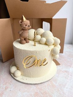 a birthday cake with a teddy bear on top