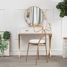 a white desk with a gold bow on it and a mirror in front of it