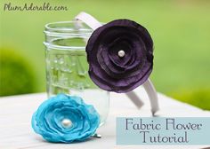 two flowers are sitting in a jar on a table with the words fabric flower tutor written below it