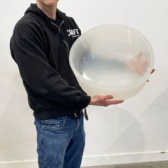 a man holding a large white object in his hands