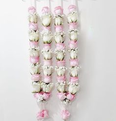 flowers are arranged in the shape of letters on a white background with pink ribbons and bows