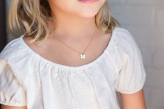 "Cute BUTTERFLY INITIAL necklace for little girls, toddler, or baby. This adorable initial necklace makes the perfect personalized gift for any girl, any age! They will smile with excitement when they unbox their very own cute initial necklace! It's simple, classic design will be popular and trendy for many years to come. Each matte gold or silver butterfly charm is strung from a sturdy diamond-cut chain. Strong enough to stand up against anything your little one may do! Your little one will be Cute Butterfly Charm Necklace For Gift, Cute White Everyday Necklace, Cute Everyday White Necklace, Cute Butterfly Necklace For Gift, White Dainty Name Necklace For Birthday, Dainty White Name Necklace For Birthday, Cute White Custom Name Necklace, Cute White Necklace With Custom Name, White Hypoallergenic Necklace For Birthday