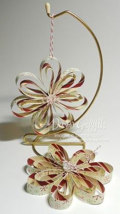 an ornament made out of paper and ribbon