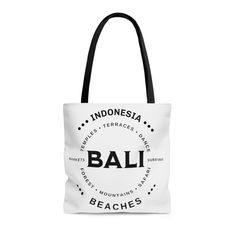 "Balinese Canvas Tote Bag,  Bali Vacation Tote, I love Bali Tote Bag, Bali Lover Gift, Travel Tote, Bali Souvenir, Bali Surf Tot, Tote Bag The Design is on both sides of the bag.  This practical, high-quality Tote Bag is available in three sizes. All over print provides comfort with style at the beach or out in town. Made from reliable materials, lasting for seasons. .: 100% Polyester .: Boxed corners .: Black inner stitching, transparent thread on hems. .: Black cotton handles .: With non-woven White Beach Bag With Letter Print For Travel, White Letter Print Beach Bag For Travel, White Travel Beach Bag With Letter Print, White Rectangular Beach Bag For Gift, Gift Beach Tote Bag With Adjustable Strap, Rectangular White Beach Bag For Gifts, Gift Beach Tote With Adjustable Strap, Adjustable Strap Tote Beach Bag Gift, White Travel Shoulder Bag