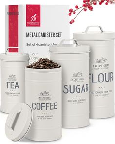 three white canisters with coffee beans in them and the box next to them