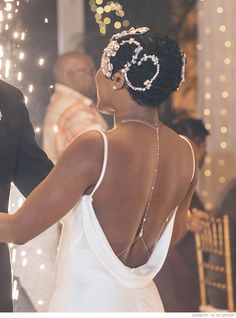 the bride and groom are dancing together at their wedding reception with sparkle in the background