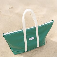 Step out in style with our stunning Forest Green Steeletex Zip Top Beach Tote. Crafted from durable vinyl, this chic tote is both water and tear-resistant, ensuring it stays pristine with minimal effort. The elegant 10" handle drop allows you to carry it over your shoulder effortlessly, freeing your hands, so you can do things like sending quick texts and enjoying your coffee. Featuring a zippered top and an interior pocket, this tote keeps your essentials secure and organized, making it the per Green Tote Shoulder Bag For The Beach, Green Beachy Tote Beach Bag, Rectangular Green Beach Bag, Green Rectangular Canvas Beach Bag, Eco-friendly Green Beach Bag With Leather Handles, Beach Tops, Beach Tote, Forest Green, Personalized Products