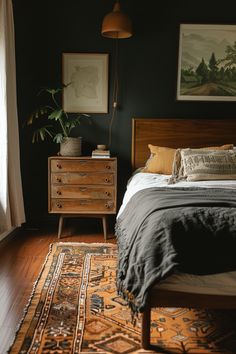 a bedroom with dark green walls and wooden furniture