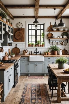 a kitchen filled with lots of counter top space and wooden flooring next to a window