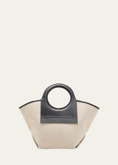 "Find HEREU Cala Small Canvas Tote Bag on Editorialist. HEREU \"Cala\" tote bag in canvas and calf leather Ring cutout top handles Shoulder strap, 32.7\" drop Open top with selftie closure Cotton lining Approx. 11.8\"H x 21.3\"W x 9.1\"D Wipe clean Made in Spain" Chic Coated Canvas Bucket Bag With Top Handle, Top Handle Canvas Shopping Bag, Chic Bucket Bag With Leather Trim And Top Handle, Designer Canvas Bag With Detachable Handle For Everyday, Designer Canvas Bags For Summer, Designer Summer Canvas Bags, Chic Coated Canvas Bucket Bag With Handles, Canvas Bucket Bag With Detachable Top Handle, Canvas Bucket Bag With Shoulder Strap