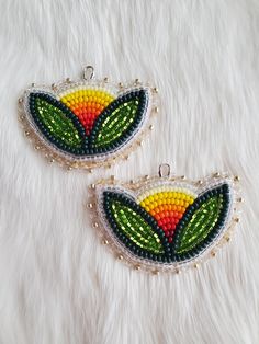 Made with a mix of czech and miyuki seed beads, backed in golden deer hide on kidney hooks.