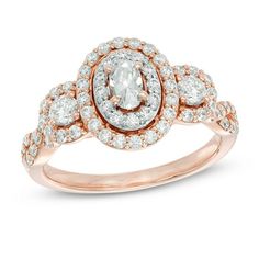 a rose gold ring with an oval cut diamond surrounded by smaller round diamonds on the band