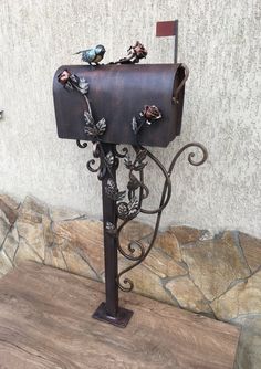 a mailbox with two birds sitting on top of it