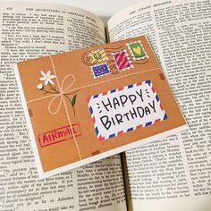 an open book with a happy birthday card on it's cover and the pages are made out of paper