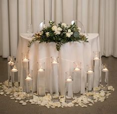 a table topped with lots of candles and flowers