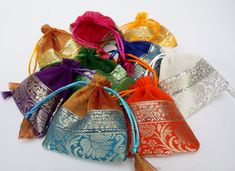 Pretty Organza Jewelry bags, You want to stand out from the crowd give your customers your jewelry pieces in these gorgeous colorful pouches. Not your typical Organza bags, these have a lovely bottom brocade trim. They come in a pack of 100 assorted colors each prettier then the other. They are well made so your customer can keep them to store the item they bought. Each pouch measures 4x4 inches and has a satin cord drawstring. I have other pouches I can source as well , so if you have something Elegant Festival Bags For Gifts, Elegant Festival Bags Suitable For Gifts, Elegant Festival Gift Bags, Elegant Multicolor Pouch For Festivals, Gold Celebration Gift Bag Pouch, Gold Gift Bag Pouch For Celebration, Elegant Multicolor Pouch For Celebration, Elegant Multicolor Pouch For Festive Occasions, Multicolor Pouch Potli Bag For Party