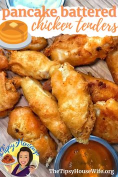 some fried chicken tenders on a plate with dipping sauce