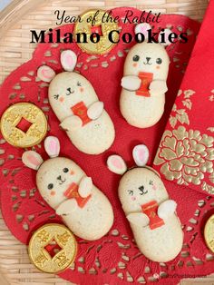 some cookies are on a red doily with gold trimmings and bunny ears