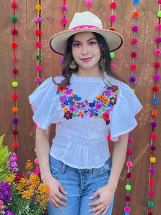 This beautiful Flounce Sleeve Top is the perfect Top for a fun day out or special event. The adorable fluttery sleeves and colorful hand embroidered flowers make it flirty and fun. It's made out of fine Mexican cotton, has an elastic waist and has colorful flowers embroidered completely by hand. This blouse is made with love by Mexican Artisans in Chiapas, Mexico. Please note: This blouse comes in one size which fits sizes Small and Medium. Purchase the Mexican hats here: https://www.etsy.com/es White Embroidered Top For Festival, Multicolor Embroidered Spring Festive Top, Summer Festive Blouse With Floral Embroidery, Festive Floral Embroidered Summer Blouse, Spring Festive Embroidered Short Sleeve Top, Festive Floral Embroidered Blouse For Summer, Festive Spring Embroidered Top With Short Sleeves, Festive Embroidered Short Sleeve Top For Spring, Fitted White Festival Top