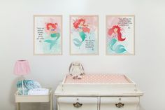 a baby's room with two pictures on the wall