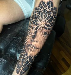 a man with a tattoo on his arm has a woman's face and flower of life