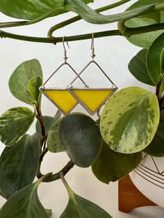 Yellow earrings made with real stained glass. Each pair is made with 100% lead-free solder, so they're safe to wear. They're lightweight (0.1 oz per earring) and one-of-a-kind. The yellow glass used for these earrings is mostly solid and just barely see-through. These triangles hang at about 4.5cm in length. Earring hooks are hypo-allergenic. Geometric Yellow Jewelry For Gifts, Yellow Triangle, Stained Glass Earrings, Yellow Earrings, Earring Hooks, Glass Earrings, Soldering, Triangles, Jewelry Earrings Dangle