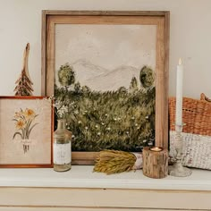 a painting and other items on a mantle