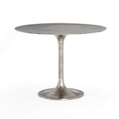 an aluminum table with a round top on a white background in the shape of a tulip