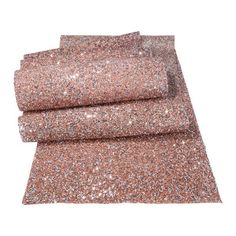 three pieces of pink glitter fabric on top of each other in different sizes and colors