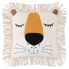 a white pillow with a tiger face on it's side and fringes around the edges